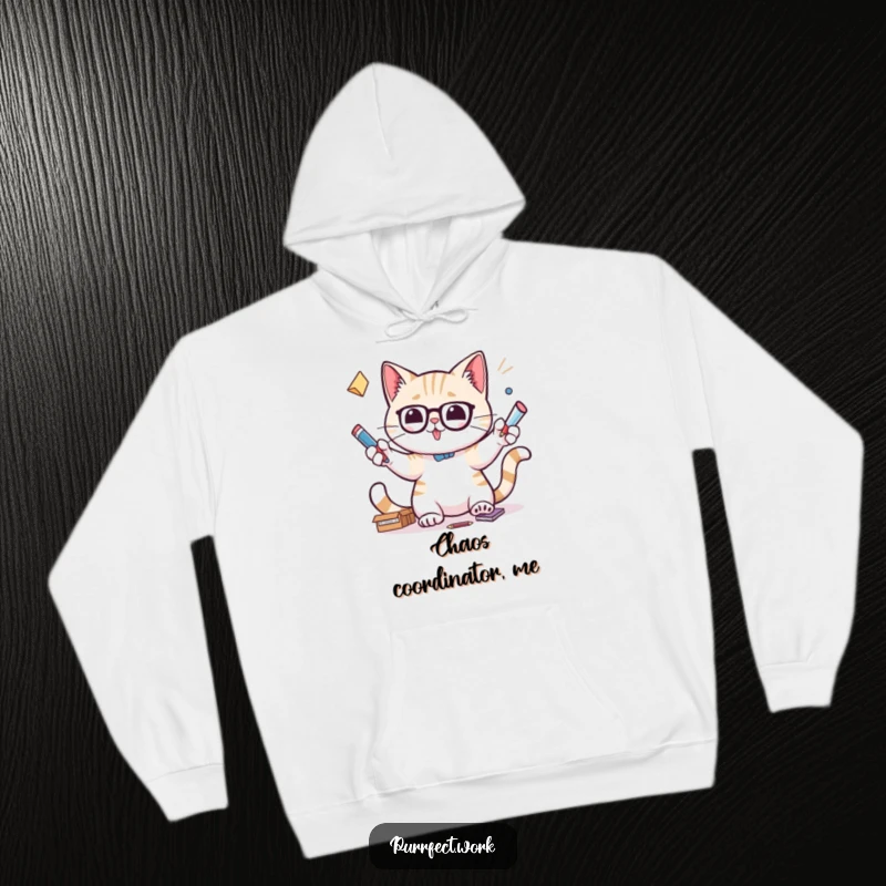 Funny hoodie depicting a cat with intense focus juggling office supplies, a symbol of skillful multitasking.