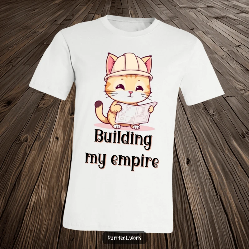 Funny t-shirt featuring a playful cat wearing a small hard hat, examining a blueprint, ready for any building task.